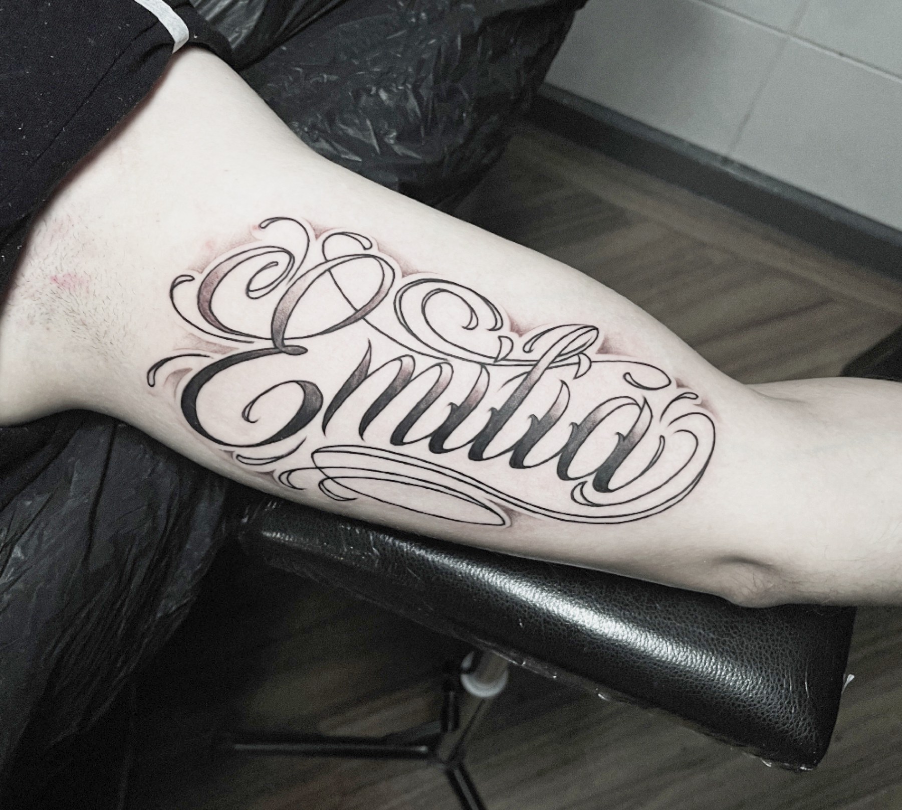 Lettering «Emilia» cursiv, tatuaj lettering de Vlad Shulea la Ace Tattoo București
